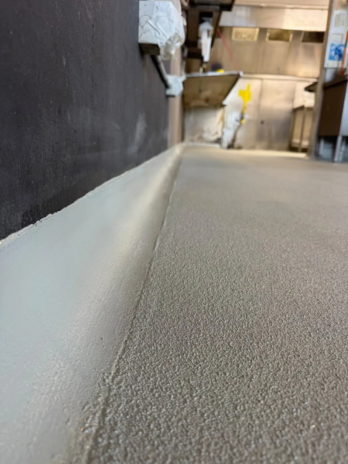 PU cement floor with coved skirting in a commercial kitchen