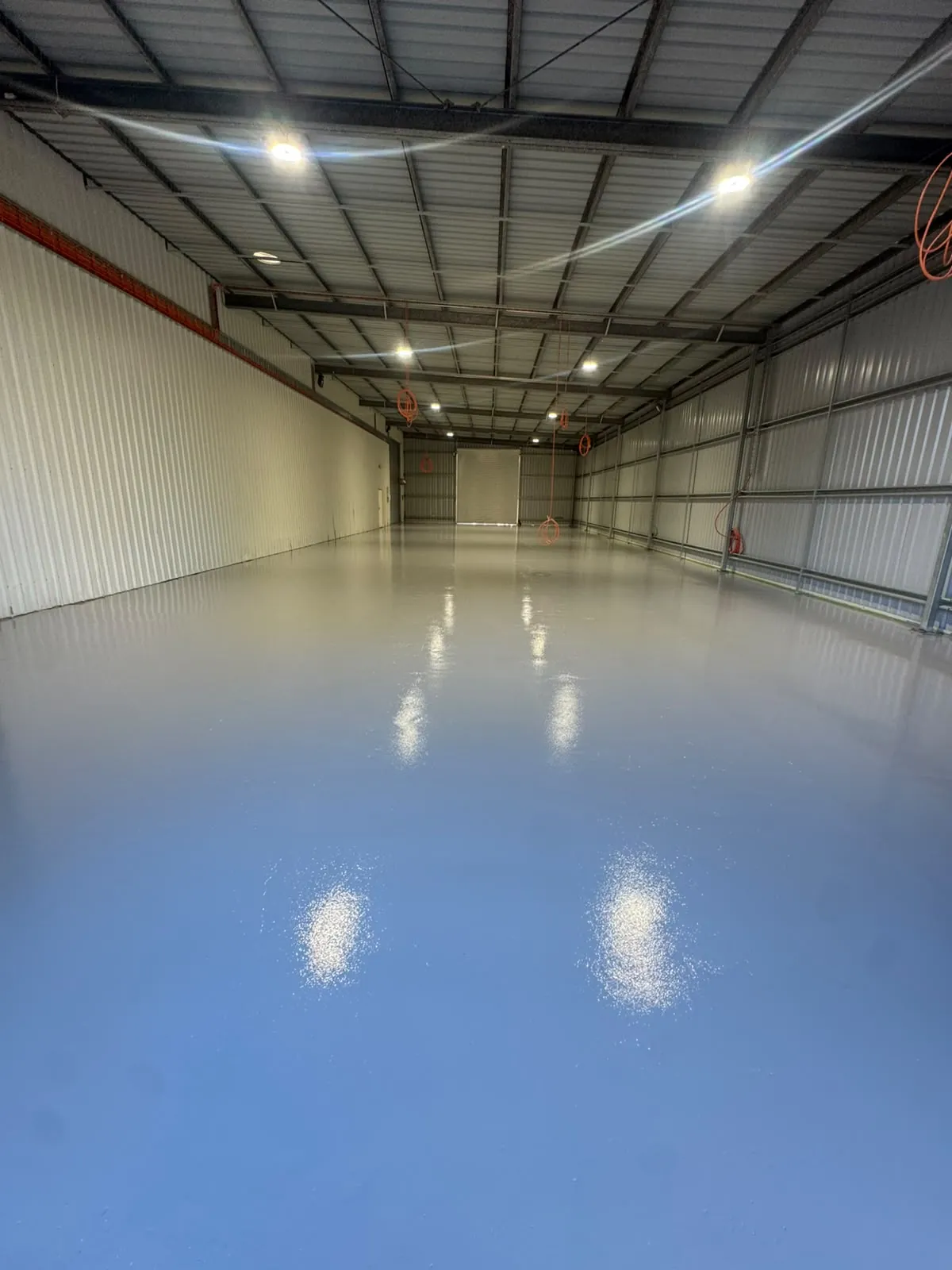 Light grey gloss epoxy floor in a large shed at Sutton Forest NSW