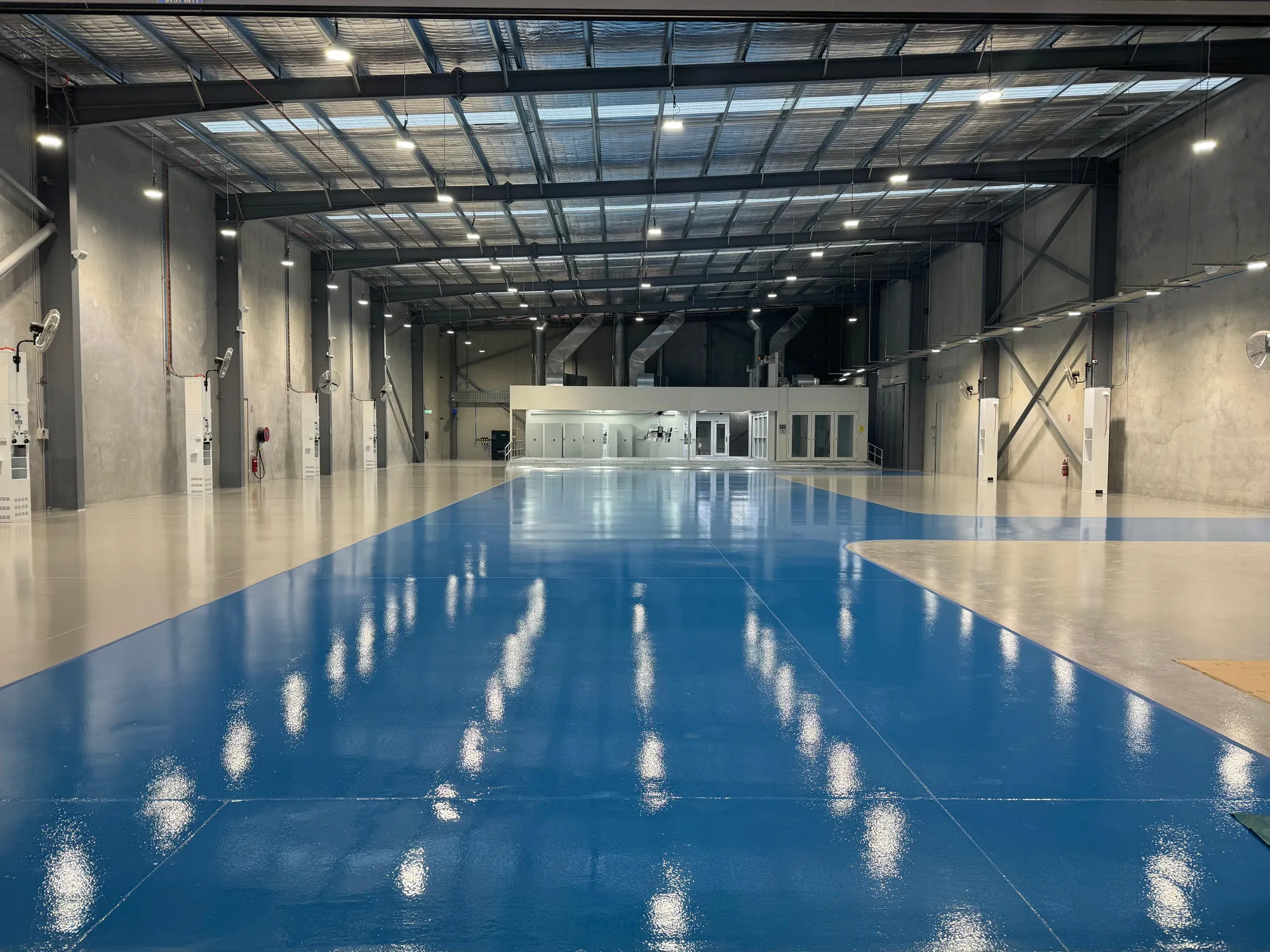 High-gloss blue epoxy floor with grey zones at RepairHub Banksmeadow