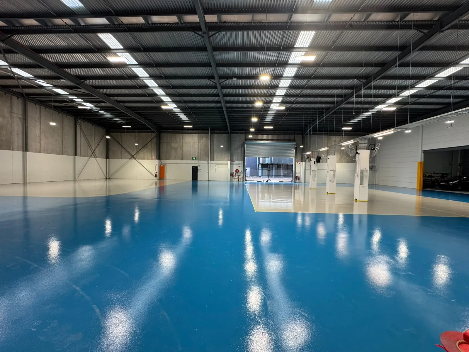 Completed two-tone epoxy floor across the RepairHub workshop, Banksmeadow