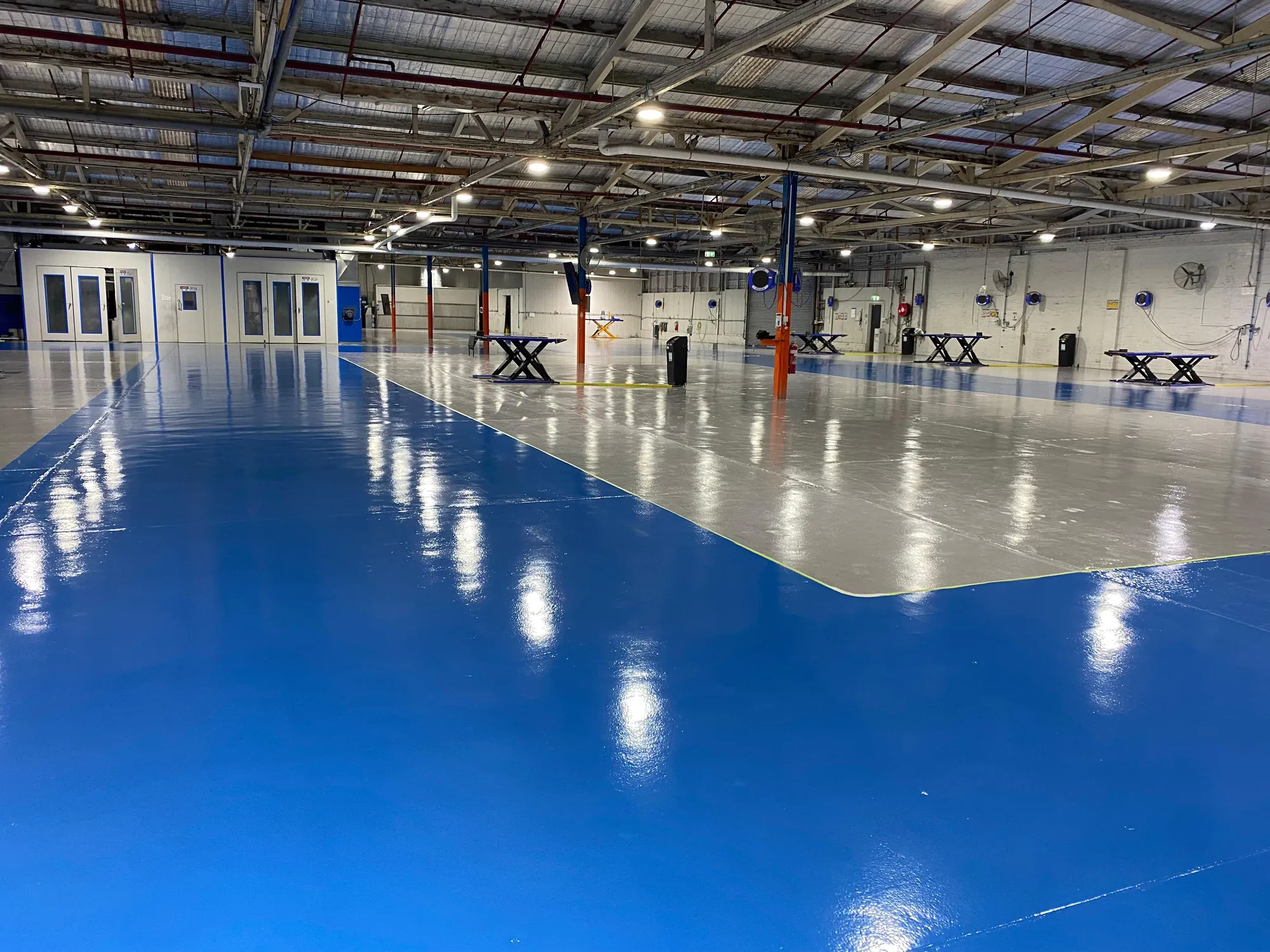 Blue and light grey two-tone epoxy floor at the RepairHub project
